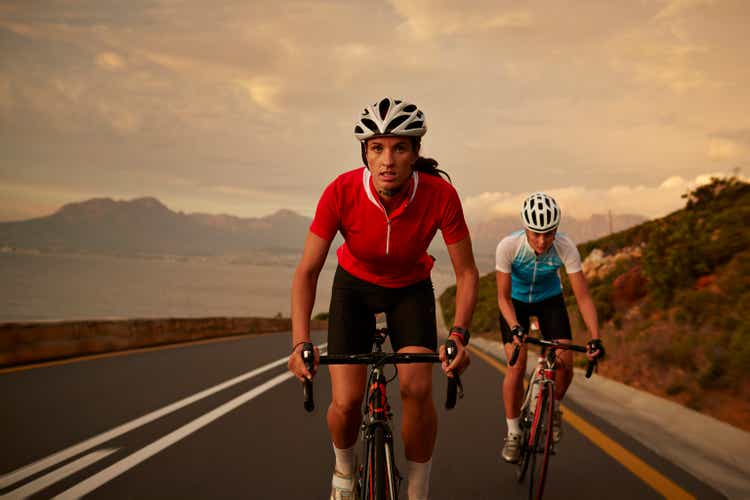 Bike rider accelerating from training partner