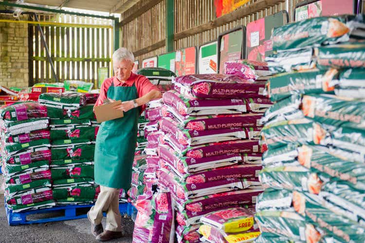 Caucasian gardener checking inventory in nursery