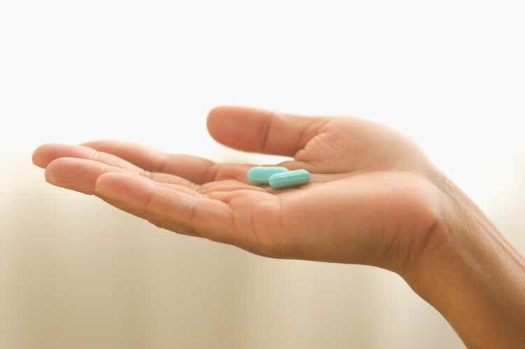 Close up of hand holding pills