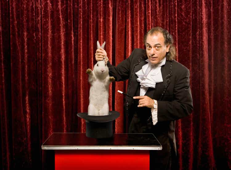 Magician pulling a rabbit out of a hat