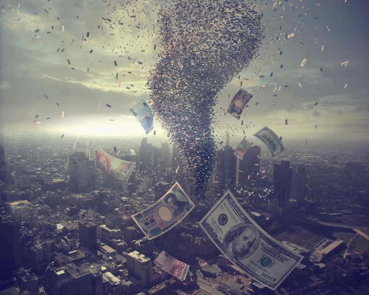 Tornado of money over cityscape