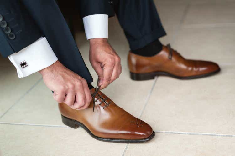 Groom tying up shoes