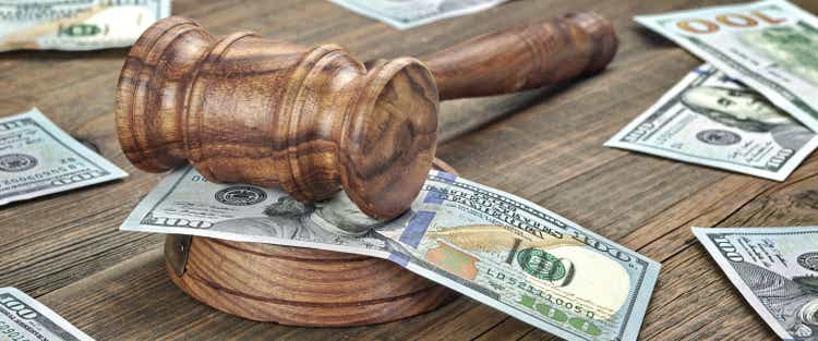 Judges or Auctioneers Gavel And Money Stack On Wooden Background