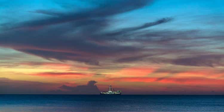 Drillship illuminated under amazing colorful twilight skyscape