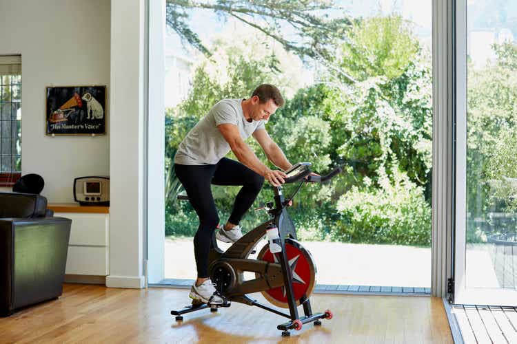 Man working out on exercise bike at home