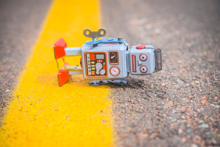 Retro robot fallen on the road