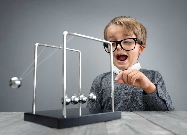 Physics and science education boy with Newton"s cradle