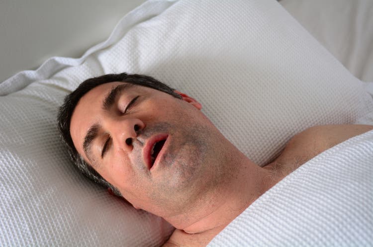 Man snoring in bed
