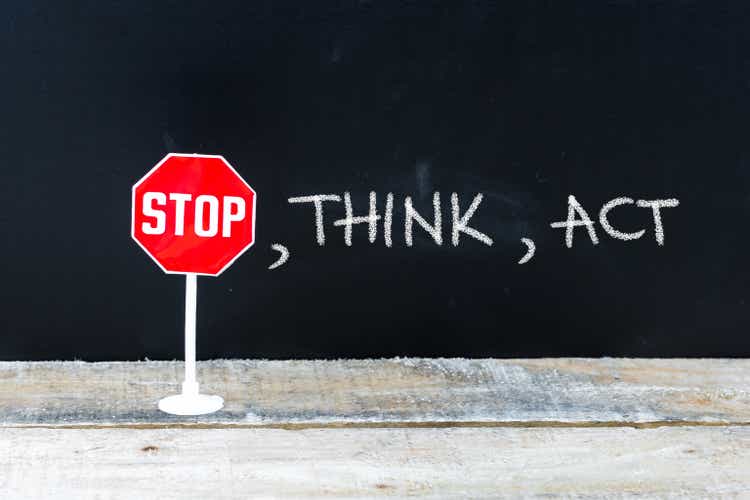 STOP, THINK, ACT message written on chalkboard