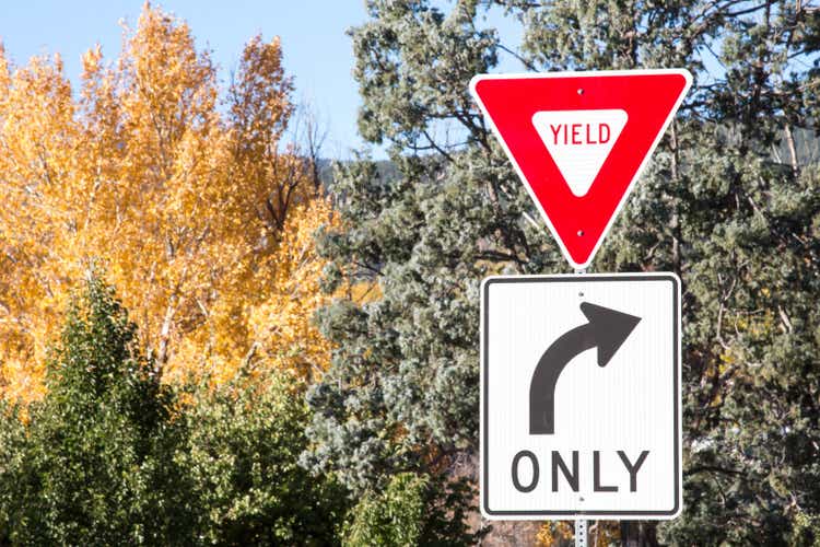 Yield and right turn only signs with autumn trees