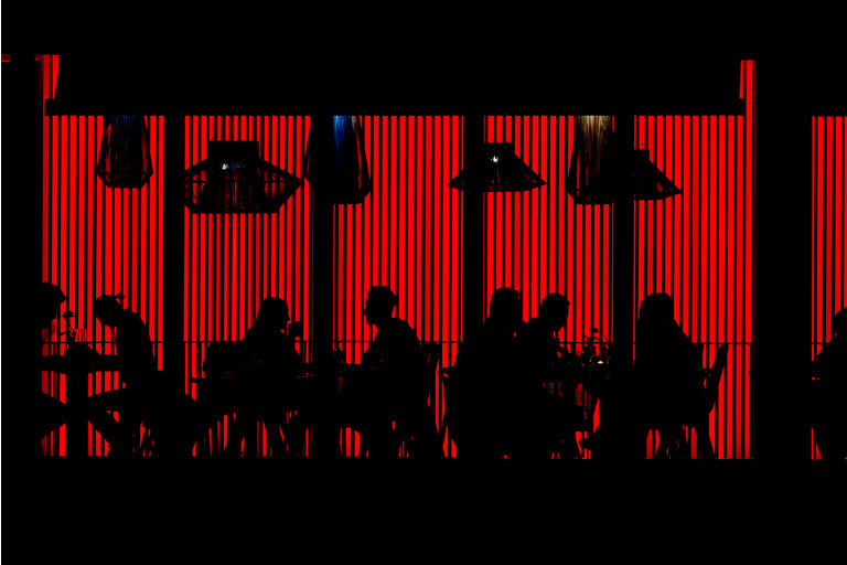 People in Red Cafe at Night