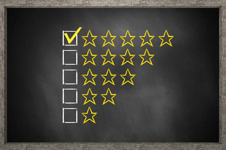 golden rating stars on black chalkboard 3D Illustration