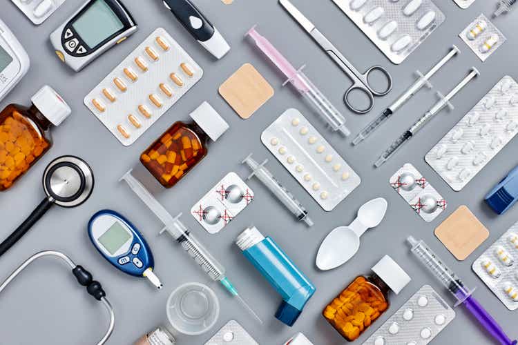 Flat lay of various medical supplies on gray background