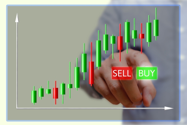 Businessman press buy button on screen with stock charts.