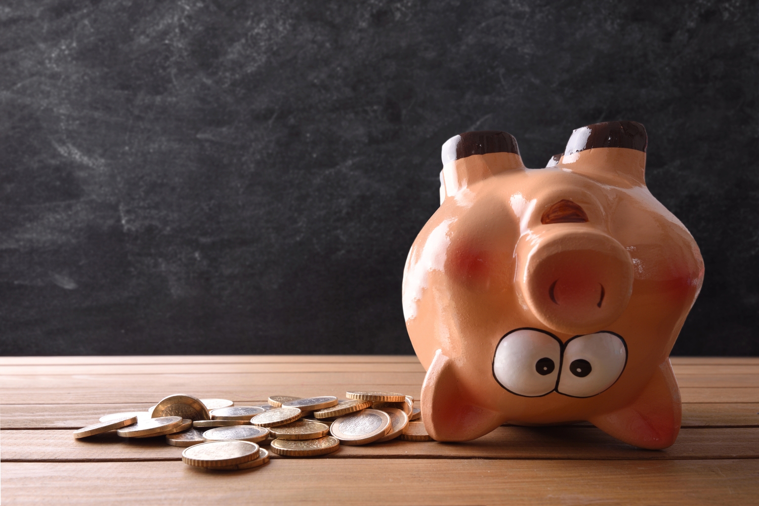 Concept of spending the savings with piggy bank upside down