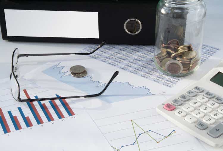 Blank folder with charts and coins
