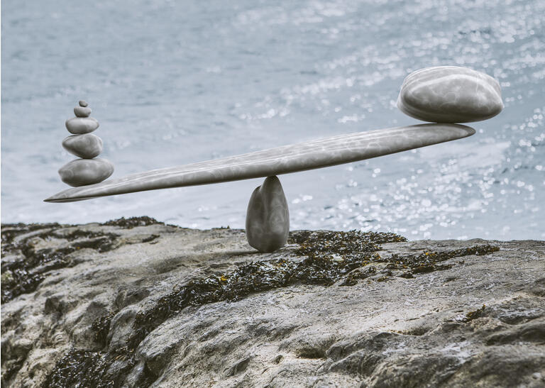 zen-like stone scales on a stone next to sea