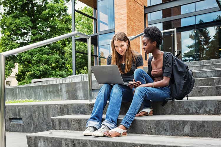 Two Female College Students on Campus with Laptop