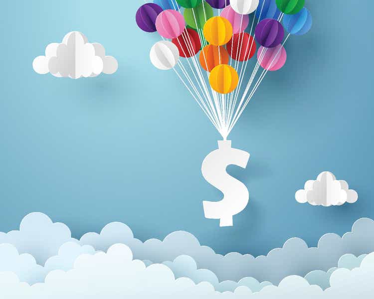 Paper art of dollar sign hanging with colorful balloon