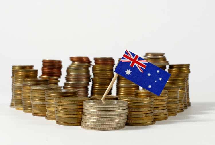 Australia flag waving with stack of money coins