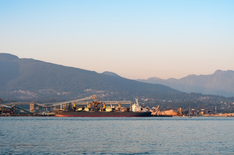 Drybulk freight ship charging/discharging cargo in Vancouver harbour