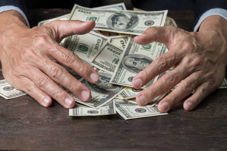 Man hands sweeping money,business concept.