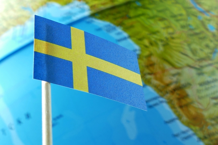Sweden flag with a globe map as a background macro