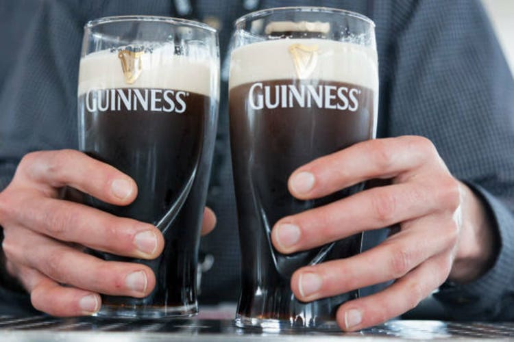 Hands holding Guinness Beer