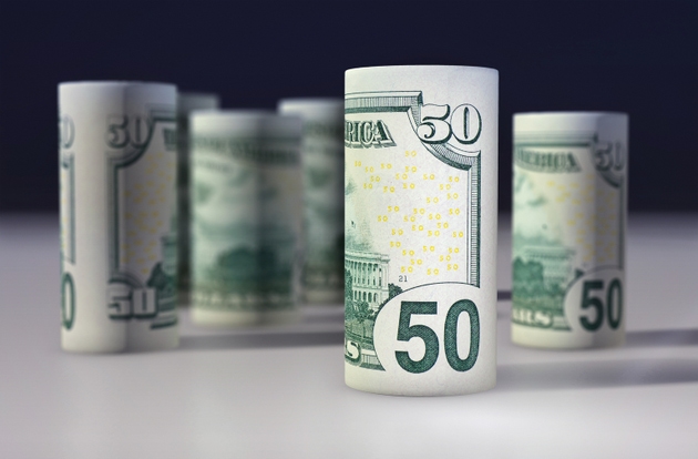 American 50 dollars greenback rolled up on the black