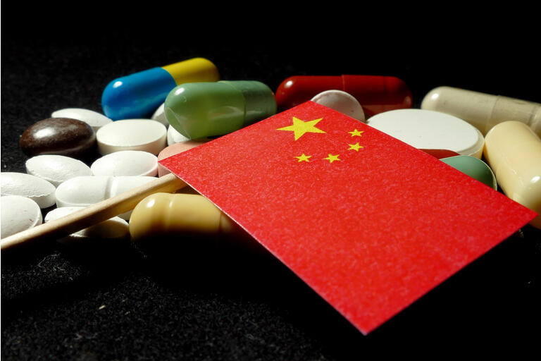 Chinese flag with lot of medical pills isolated