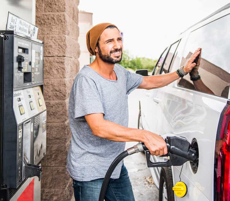 Hispanic man pumping gas