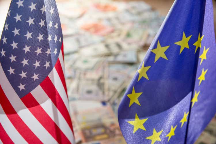 US Dollar and Euro on flags of the United States and European Union.