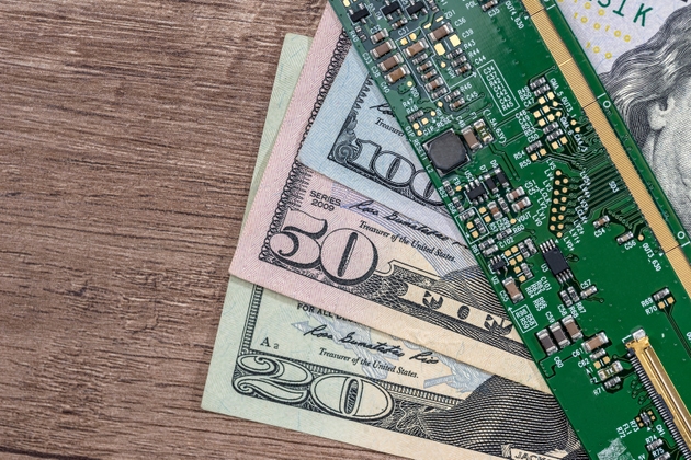 dollar bills from technology. green motherboard. close up.