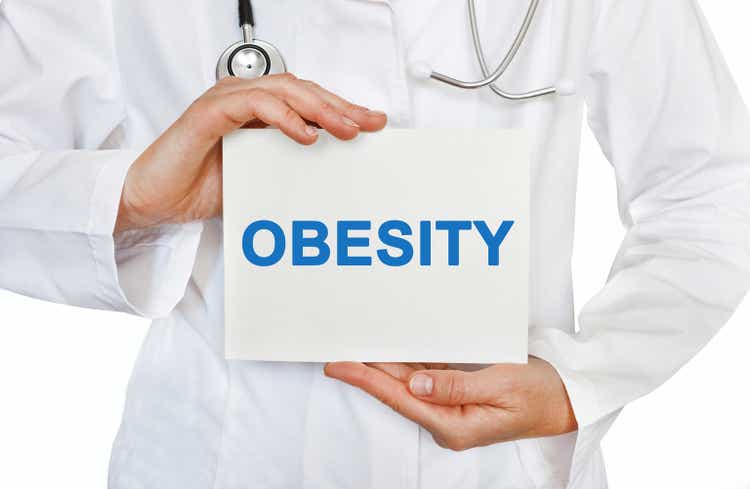 Obesity card in hands of Medical Doctor