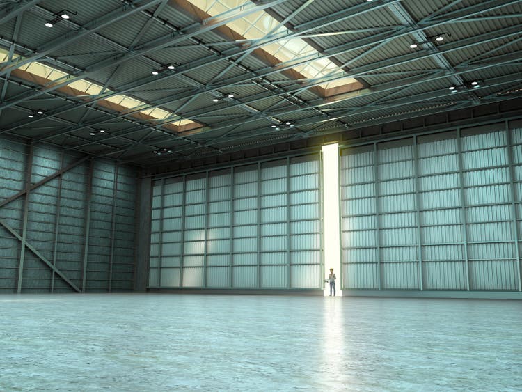 Woman in an empty warehouse by day