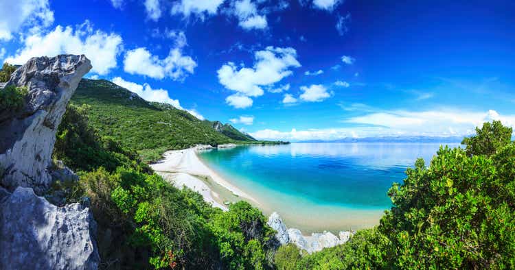 Beach, crystal clear water in Adriatic Sea and Green Mountains