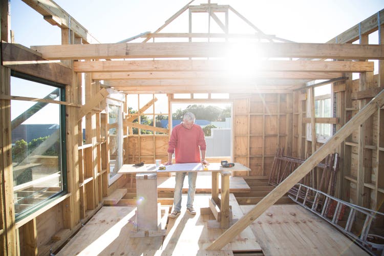Builder working on a wood framed house