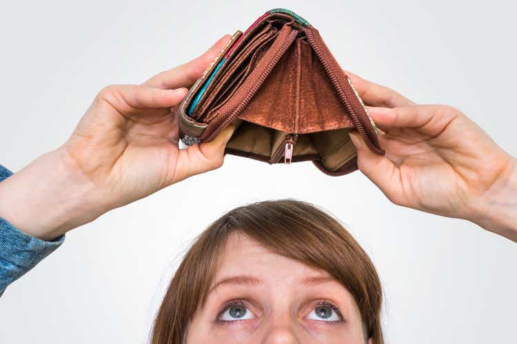 Woman holding an empty wallet, she hasn"t money