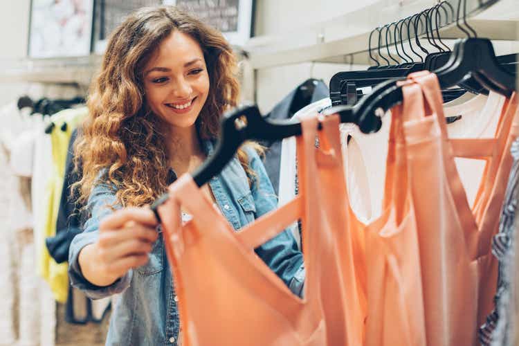 Young woman browsing in the fashion store