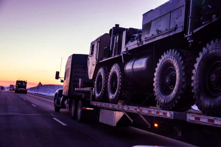 Expressway Flatbed Semi Truck Convoy Hauling Armored Military Land Vehicles