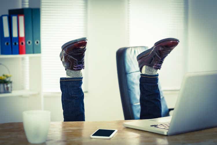 Businessman upside down at his desk