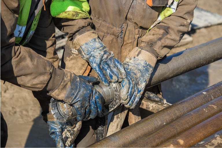 Worker hands checks a diamond core drill bit