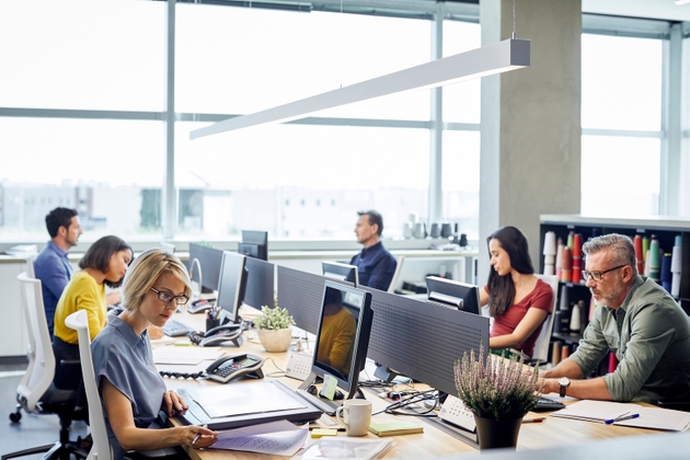 Business people working at desk by windows