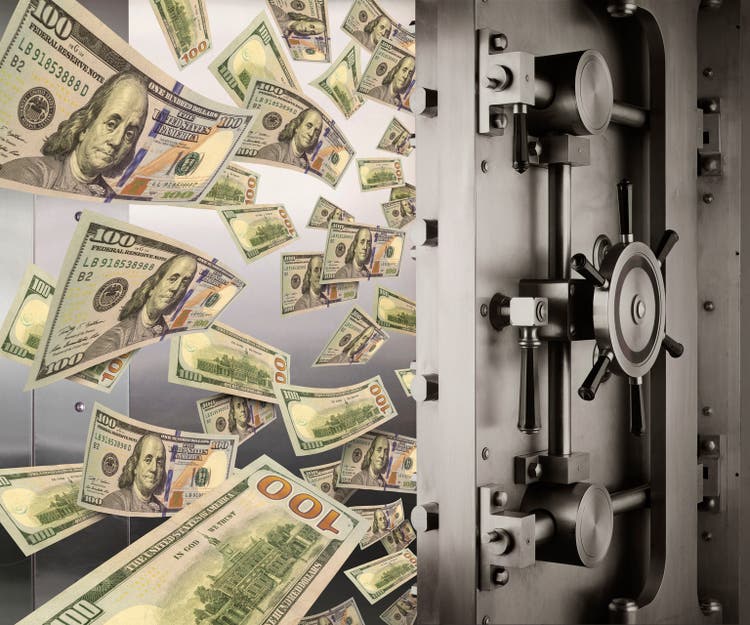 Money flowing from open vault door