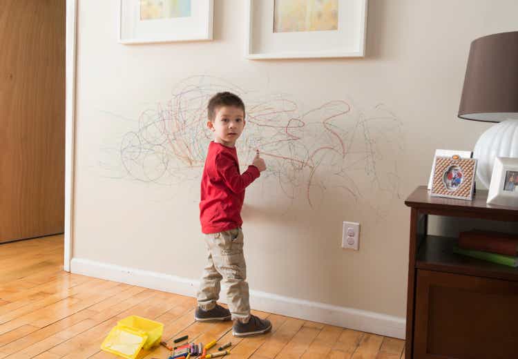 Mixed Race boy drafting connected wall pinch crayons