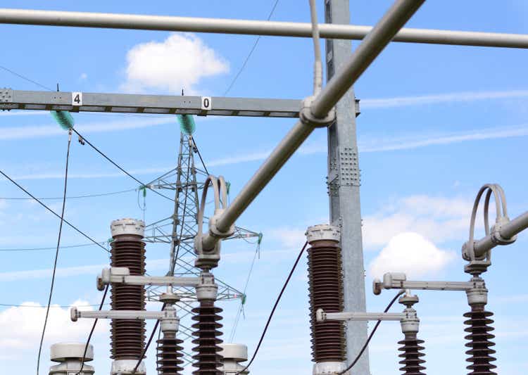 Power substation with insulators, power lines and blue sky