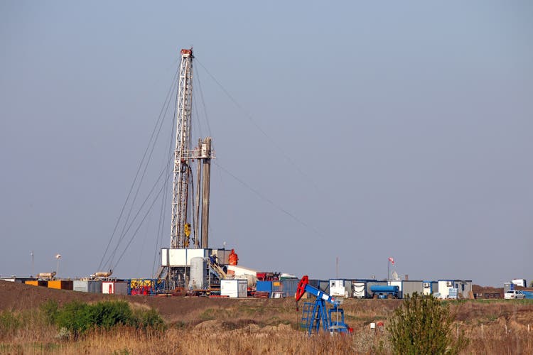 pump jack and oil drilling rig on oilfield