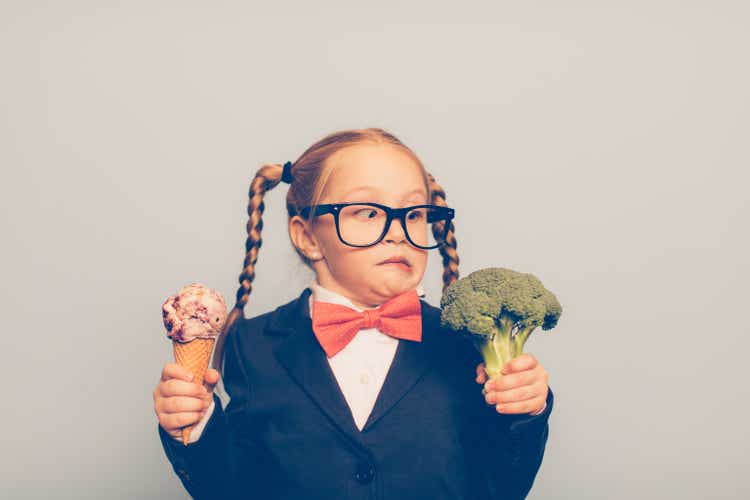 Young Female Nerd Holds Ice Cream and Broccoli