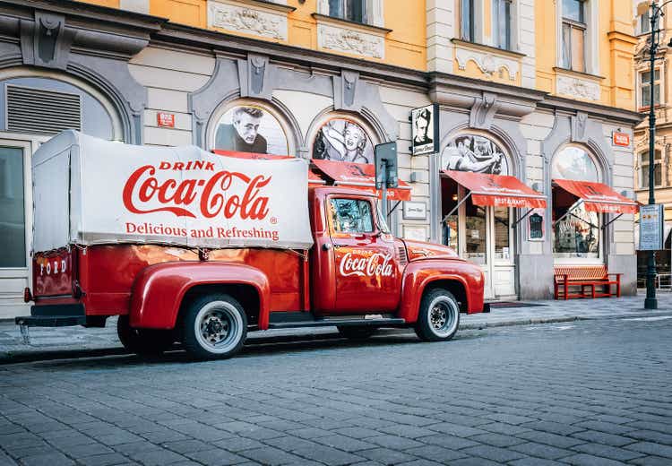 An old renovated 1930 - 1940s Coca-Cola red delivery pickup truck 1934 Ford parking on the Prague street in Prague, Czech Republic