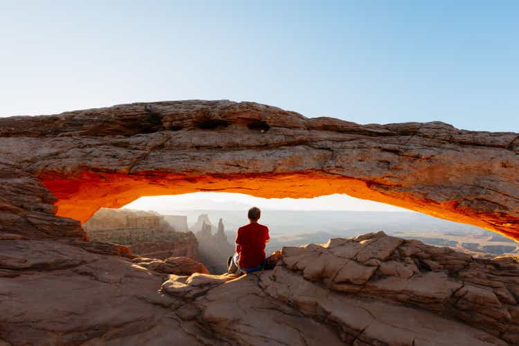 Man enjoying sunrise at Mesa arch, Canyonlands